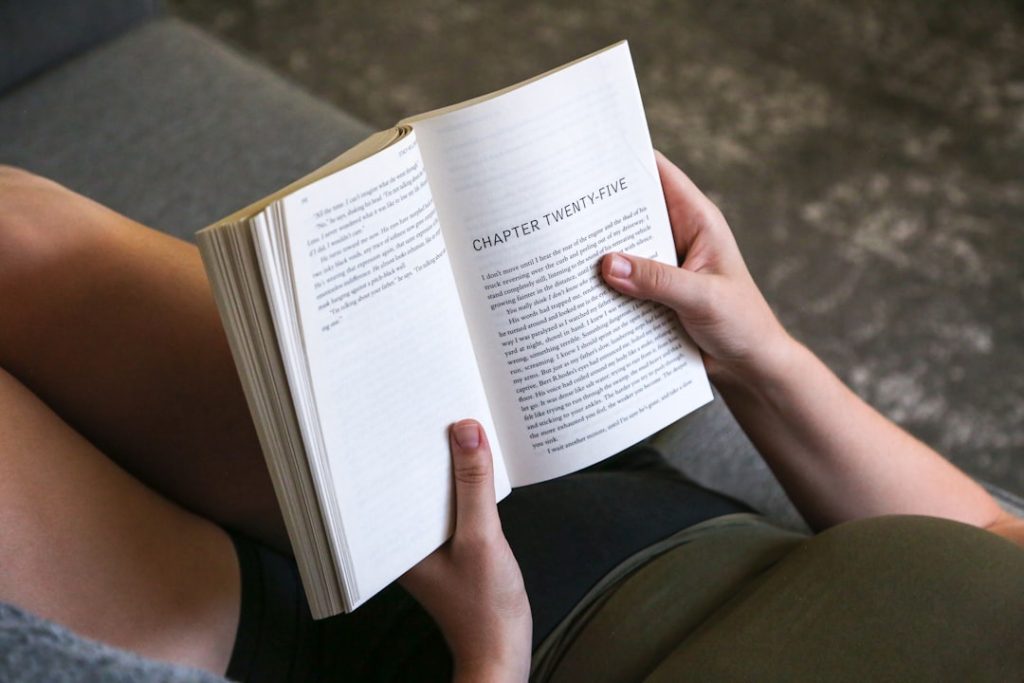 Person reading a novel showing a chapter heading, illustrating what a beginner English reader experiences when working through their first book